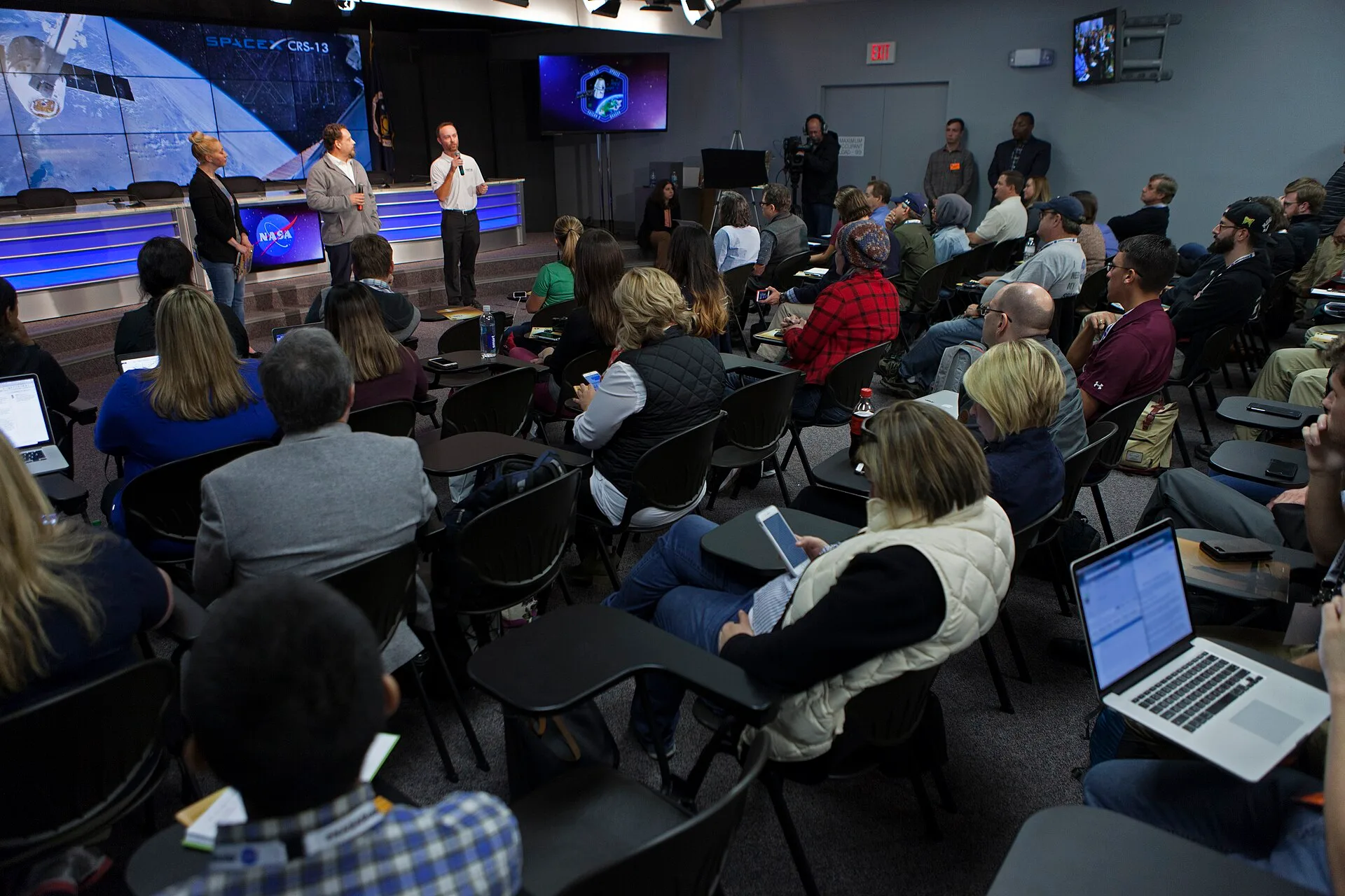 Cheryl Warner of NASA Communications, left, Kirt Costello, deputy chief scientist for the International Space Station Program at NASA’s Johnson Space Center in Houston, center, and Patrick O'Neill, Marketing and Communications manager at the Center of Advancement of Science in Space (CASIS), speak t